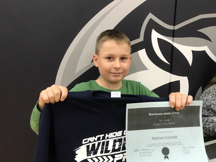 Nathan Cornett holding certificate and shirt